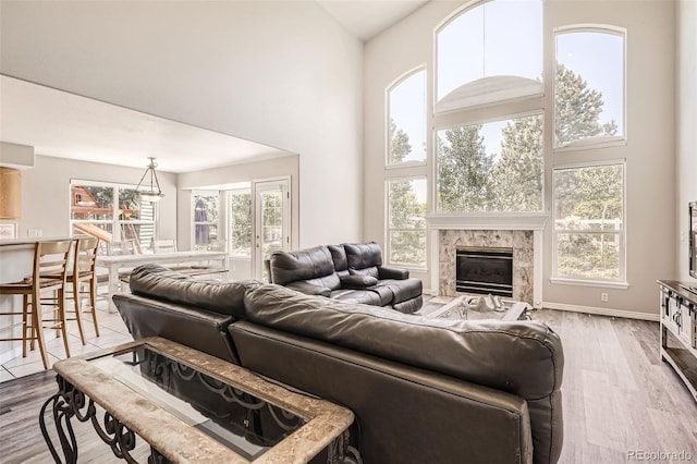 12705 Kalamath Ct, Westminster, CO 80234 - living room with a towering ceiling, wood finished floors, and a tile fireplace