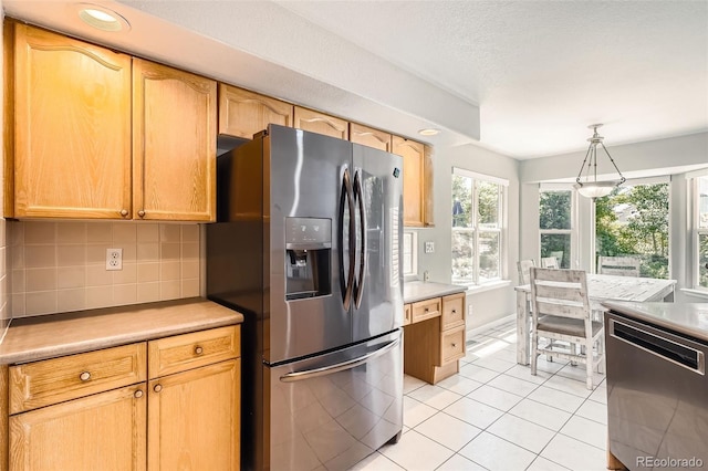 12705 Kalamath Ct, Westminster, CO 80234 - kitchen featuring appliances with stainless steel finishes, light tile patterned flooring, decorative backsplash, light countertops, and recessed lighting
