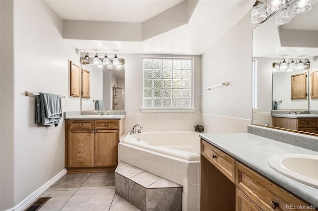 12705 Kalamath Ct, Westminster, CO 80234 - full bathroom with a bath, two vanities, and tile patterned flooring