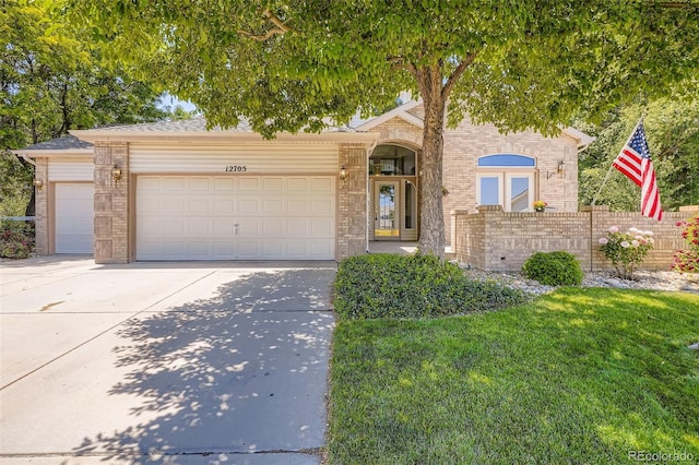 12705 Kalamath Ct, Westminster, CO 80234 - view of front of house with concrete driveway, a garage, and brick siding
