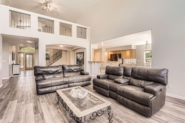 12705 Kalamath Ct, Westminster, CO 80234 - living area featuring light wood-style flooring, arched walkways, and a high ceiling