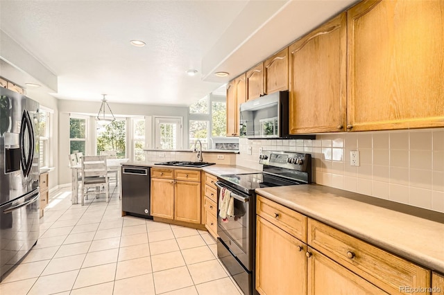 12705 Kalamath Ct, Westminster, CO 80234 - kitchen featuring appliances with stainless steel finishes, decorative backsplash, light tile patterned floors, light countertops, and a peninsula