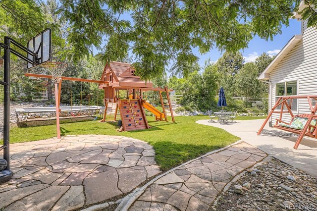 12705 Kalamath Ct, Westminster, CO 80234 - view of grassy yard with a playground and a patio area