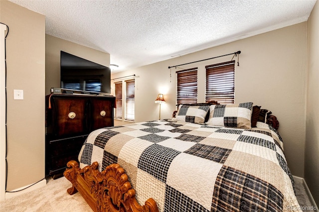 bedroom featuring a textured ceiling and light colored carpet