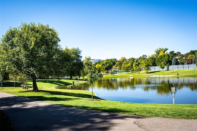 view of community featuring a yard and a water view