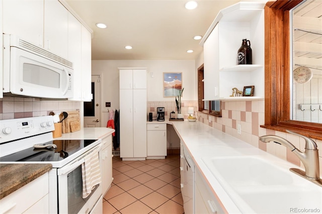 5067 S Mabre Ct, Littleton, CO 80123 - kitchen with white appliances, decorative backsplash, white cabinetry, light tile patterned floors, and recessed lighting