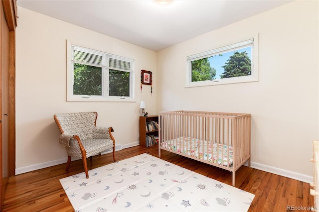5067 S Mabre Ct, Littleton, CO 80123 - bedroom with wood finished floors and a nursery area