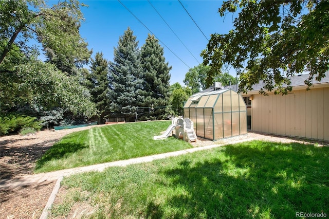 5067 S Mabre Ct, Littleton, CO 80123 - view of yard with a greenhouse and an outdoor structure