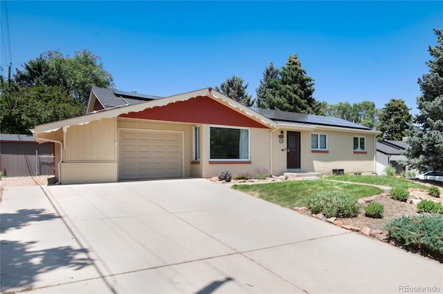 5067 S Mabre Ct, Littleton, CO 80123 - single story home with a garage, concrete driveway, and roof mounted solar panels