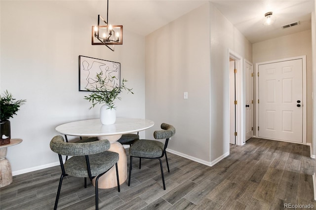 7408 S Alkire St Unit 301, Littleton, CO 80127 - dining room featuring dark wood-type flooring, baseboards, and a chandelier