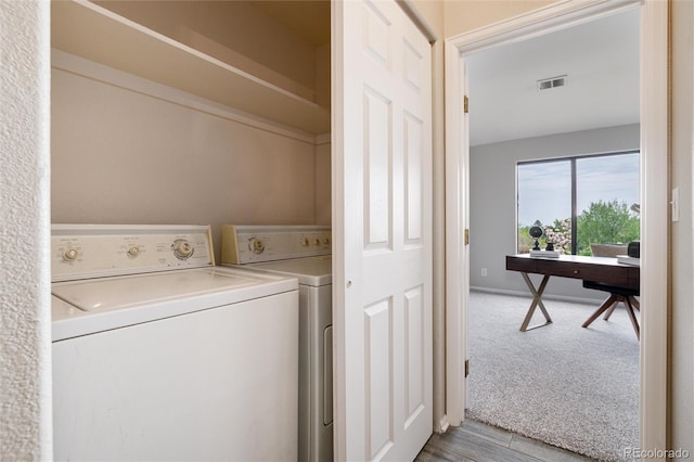 7408 S Alkire St Unit 301, Littleton, CO 80127 - laundry area with washer and dryer, a desk, light colored carpet, and baseboards