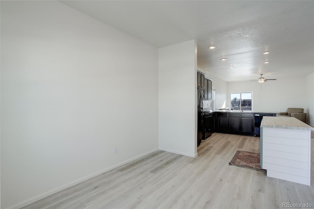 kitchen with ceiling fan, dishwasher, light wood-type flooring, and a textured ceiling