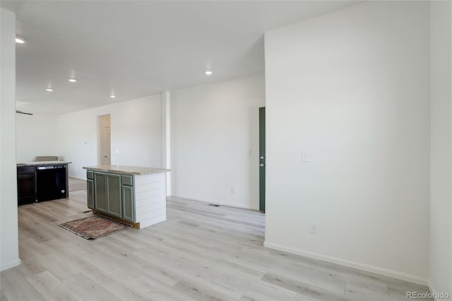 kitchen with a center island, fridge, and light hardwood / wood-style flooring