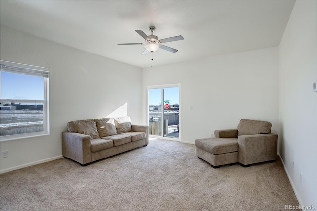 carpeted living room featuring ceiling fan