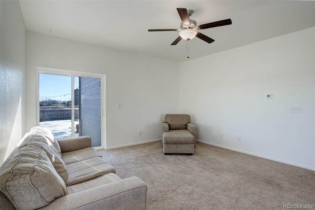 sitting room with ceiling fan and light colored carpet