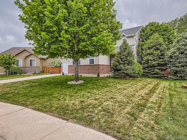8010 Raspberry Dr, Frederick, CO 80504 - obstructed view of property with brick siding and a front yard