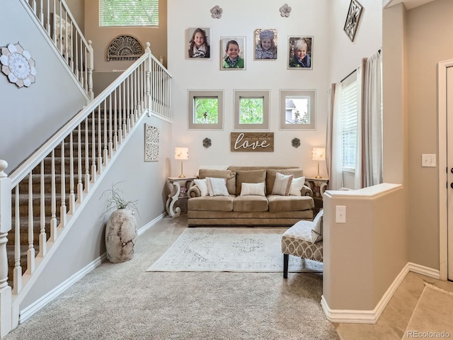 8010 Raspberry Dr, Frederick, CO 80504 - living area with a towering ceiling, stairs, baseboards, and carpet