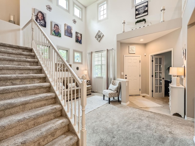 8010 Raspberry Dr, Frederick, CO 80504 - staircase featuring carpet floors, a high ceiling, and baseboards