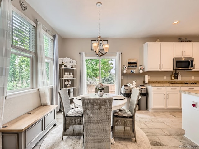 8010 Raspberry Dr, Frederick, CO 80504 - dining room with plenty of natural light, a chandelier, recessed lighting, and stone tile floors