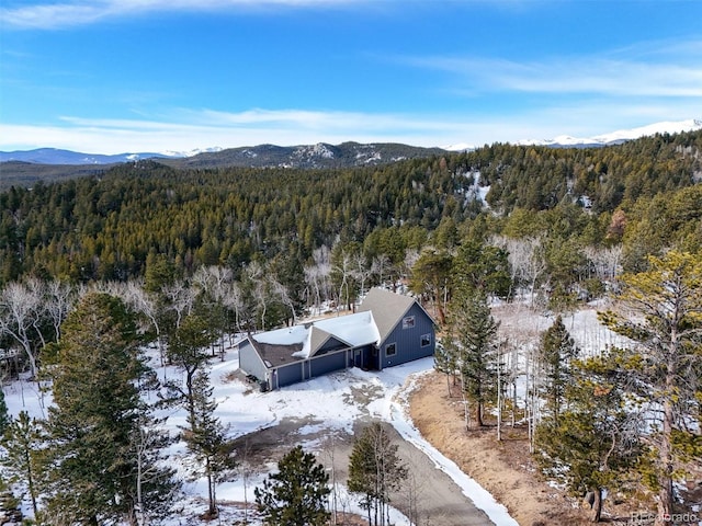 snowy aerial view with a mountain view