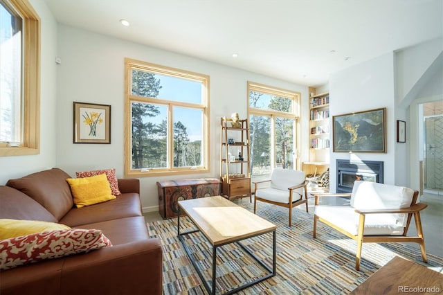 living room with a fireplace, a healthy amount of sunlight, and hardwood / wood-style flooring