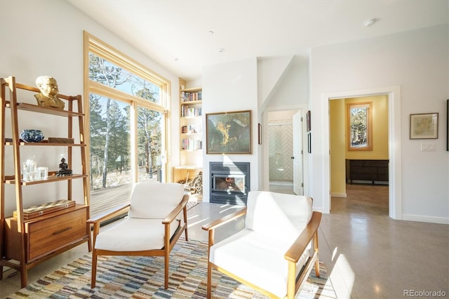 sitting room with built in features and a wood stove