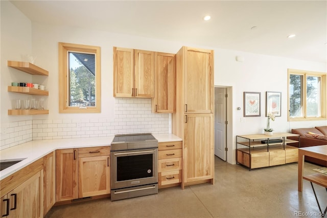 kitchen featuring tasteful backsplash, stainless steel electric range oven, and light brown cabinetry