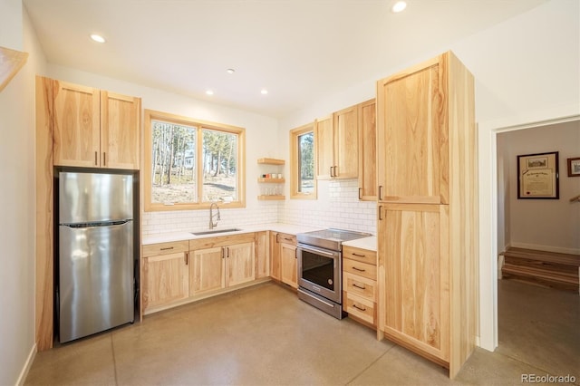 kitchen with decorative backsplash, appliances with stainless steel finishes, light brown cabinets, and sink