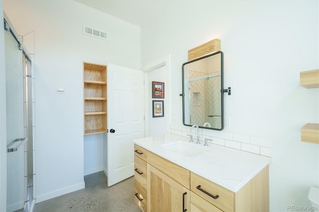 bathroom with vanity and a shower with door