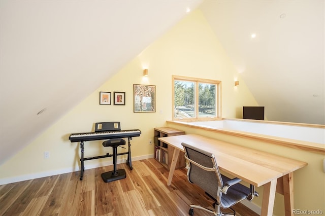 office with vaulted ceiling and hardwood / wood-style flooring