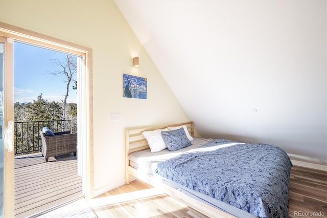 bedroom featuring hardwood / wood-style floors and lofted ceiling