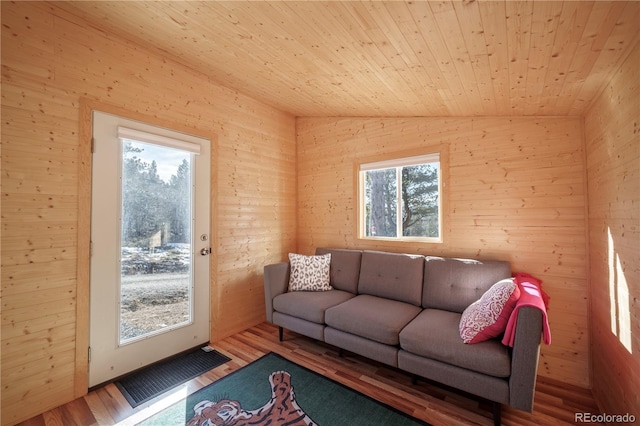 living room featuring wood-type flooring, lofted ceiling, and wood ceiling