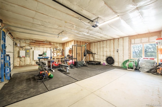 garage featuring electric panel and a garage door opener