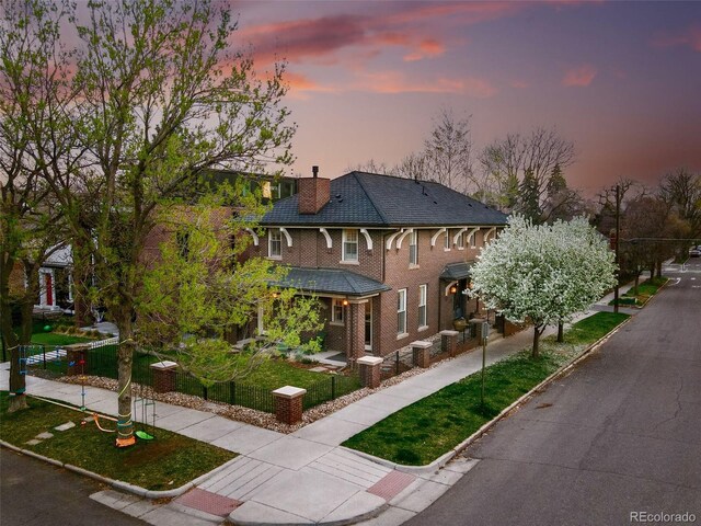 201 S Lafayette St, Denver, CO 80209 - view of front of house with a chimney and a yard