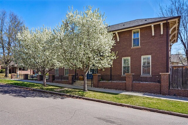 201 S Lafayette St, Denver, CO 80209 - view of front of home with a fenced front yard and brick siding