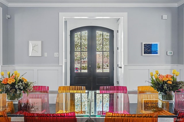 201 S Lafayette St, Denver, CO 80209 - foyer entrance with french doors, a decorative wall, crown molding, and wainscoting
