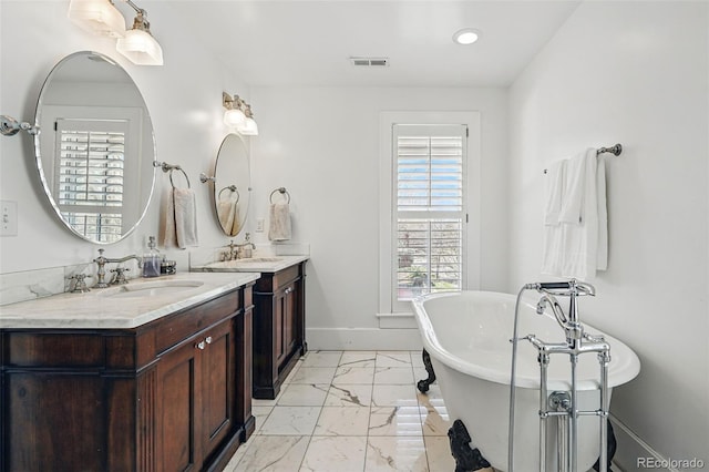 201 S Lafayette St, Denver, CO 80209 - full bathroom with marble finish floors, double vanity, and a freestanding bath