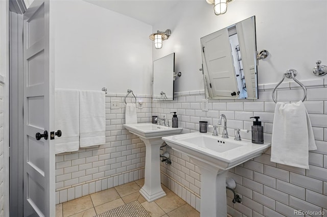 201 S Lafayette St, Denver, CO 80209 - bathroom featuring tile patterned floors, tile walls, and a wainscoted wall
