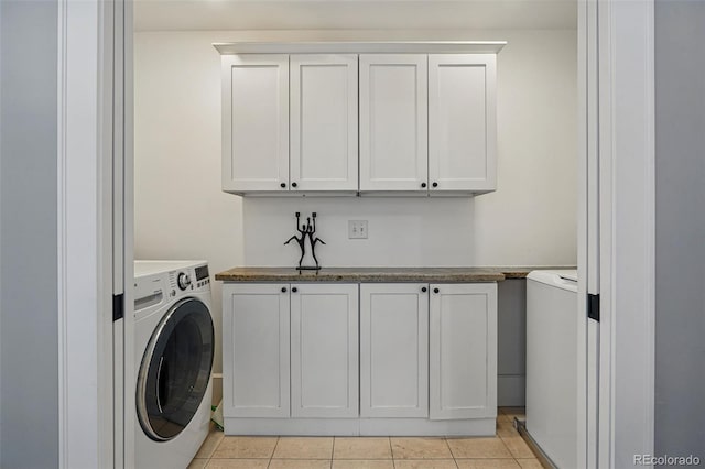 201 S Lafayette St, Denver, CO 80209 - laundry area featuring washer / clothes dryer, light tile patterned floors, and cabinet space