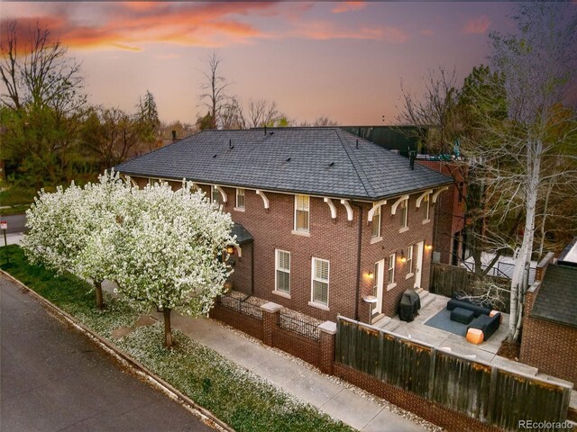 201 S Lafayette St, Denver, CO 80209 - back of property featuring a fenced front yard and brick siding
