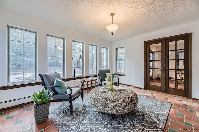 sitting room featuring a textured ceiling, french doors, and baseboards