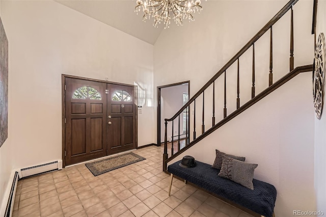 entryway with a baseboard radiator, a high ceiling, baseboard heating, and stairs