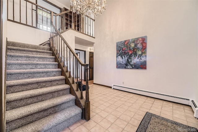 stairway featuring a baseboard radiator, a high ceiling, baseboards, tile patterned floors, and an inviting chandelier