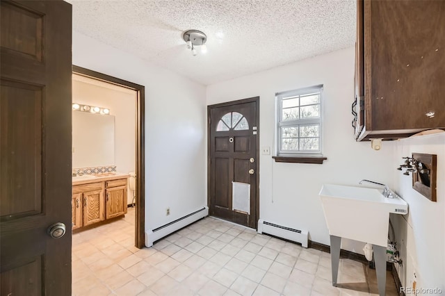 entryway with a baseboard heating unit, a baseboard radiator, and a textured ceiling