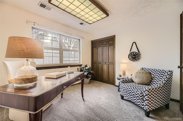 home office with carpet floors, baseboards, visible vents, and a textured ceiling