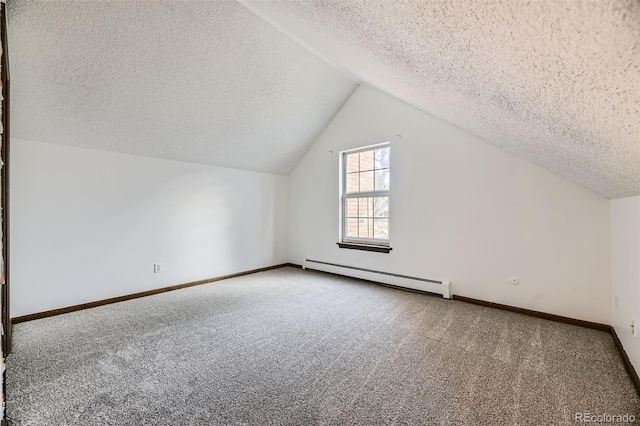 bonus room with a baseboard heating unit, carpet floors, lofted ceiling, and baseboards