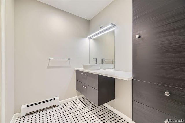 bathroom with baseboard heating, vanity, and baseboards