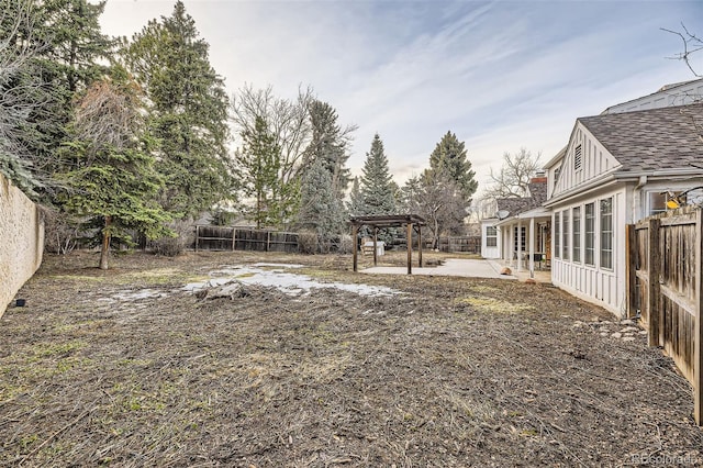 view of yard with a patio area, a fenced backyard, and a pergola