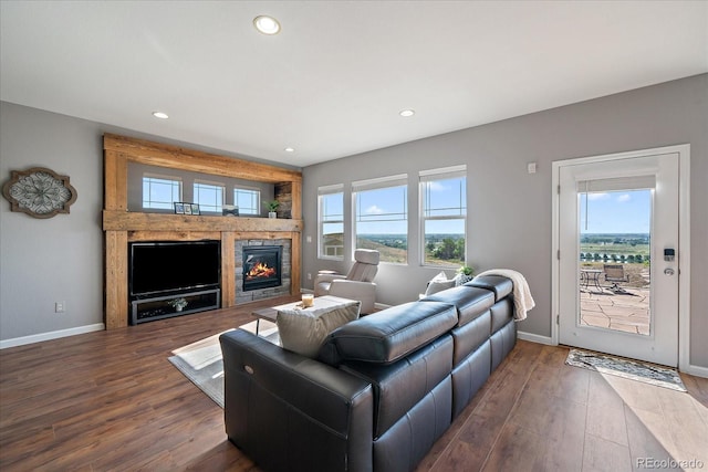 12420 Verbena St, Thornton, CO 80602 - living room with a stone fireplace, dark wood-style flooring, and recessed lighting