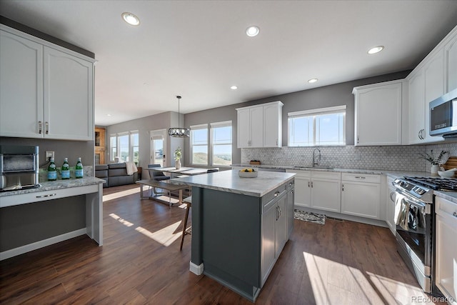 12420 Verbena St, Thornton, CO 80602 - kitchen featuring stainless steel appliances, healthy amount of natural light, backsplash, and recessed lighting